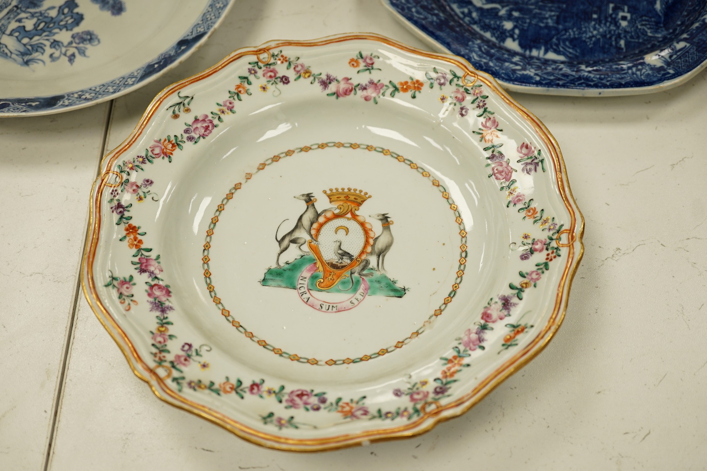 A Chinese export armorial soup plate, for the Spanish market, Qianlong period, with a Spanish coat of arms, possibly Aguado de Las Marismas, an 18th century Chinese export punch bowl on stand, a Chinese blue and white pl